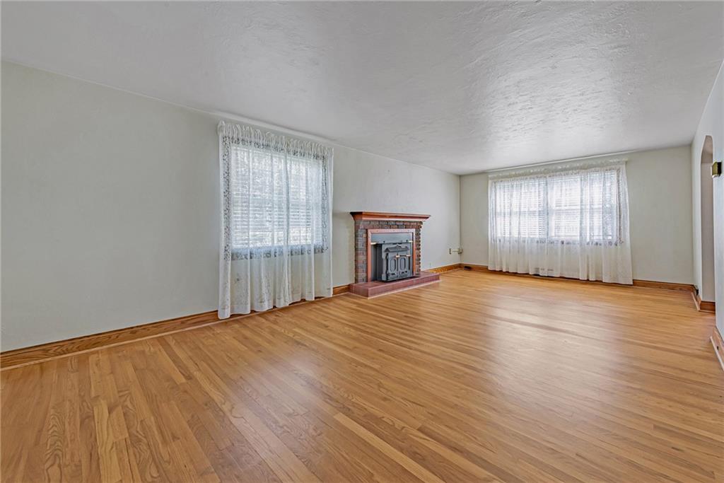 1431 New Stanton Ruffsdale Road Ruffs Dale, PA 15679 - Photo 4 of 25 an empty room with wooden floor and windows