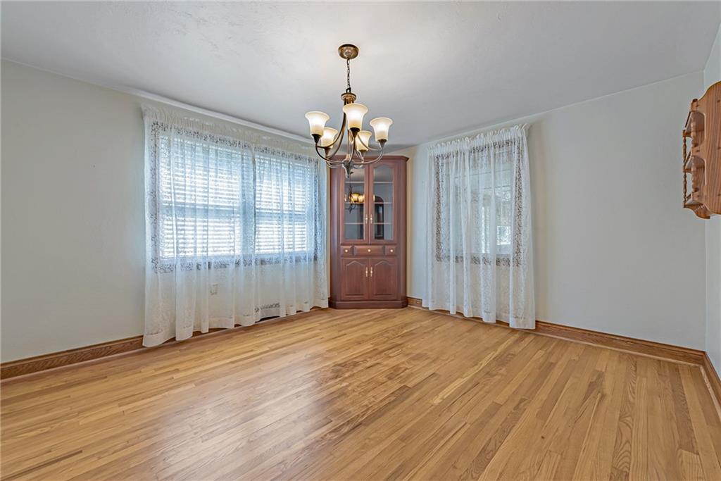 1431 New Stanton Ruffsdale Road Ruffs Dale, PA 15679 - Photo 5 of 25 a view of an empty room with wooden floor and a window