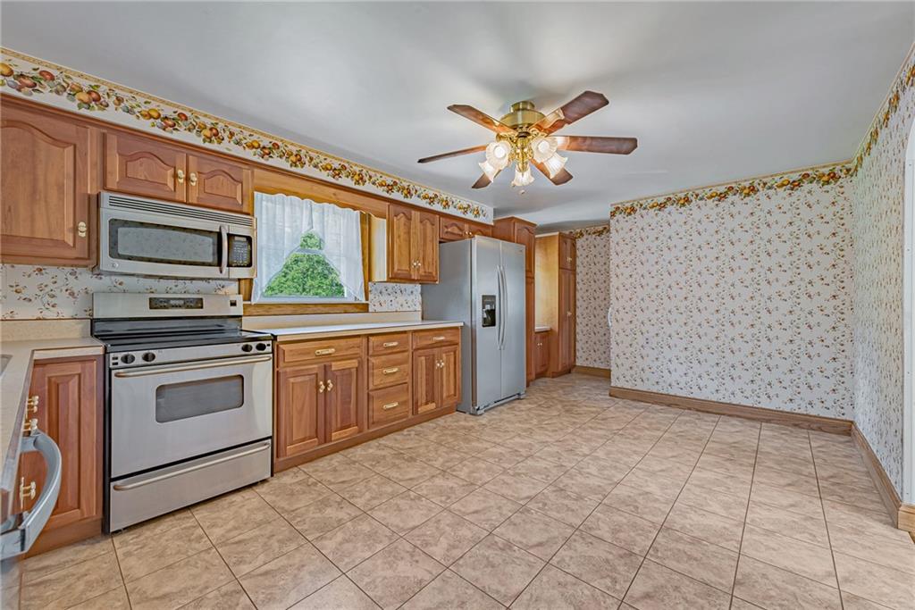 1431 New Stanton Ruffsdale Road Ruffs Dale, PA 15679 - Photo 6 of 25 a kitchen with stainless steel appliances a stove a sink and a refrigerator