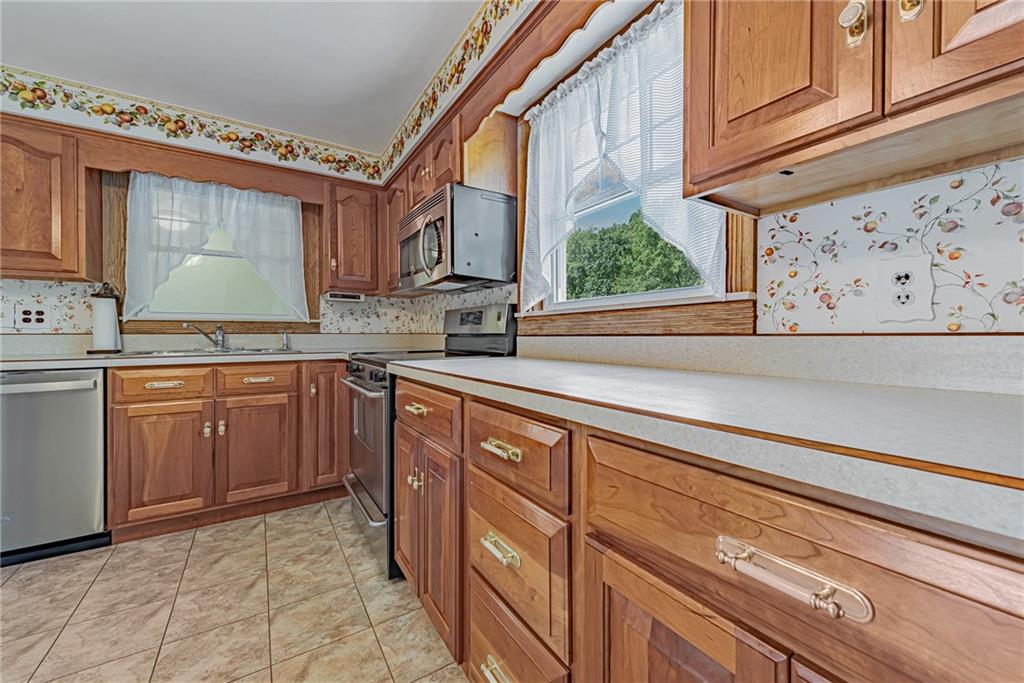 1431 New Stanton Ruffsdale Road Ruffs Dale, PA 15679 - Photo 8 of 25 a kitchen with stainless steel appliances granite countertop a sink and cabinets