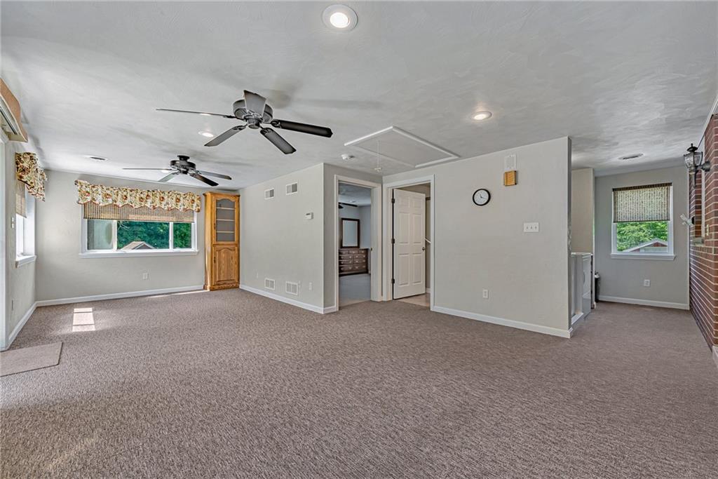 1431 New Stanton Ruffsdale Road Ruffs Dale, PA 15679 - Photo 9 of 25 a view of a livingroom with a ceiling fan and window