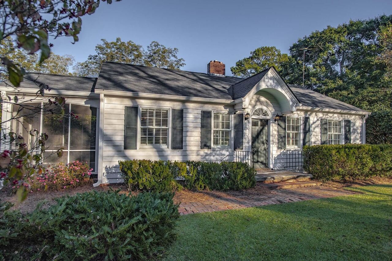 1069 Eatonton Road Madison, GA 30650 - Photo 1 of 1 a front view of a house with garden
