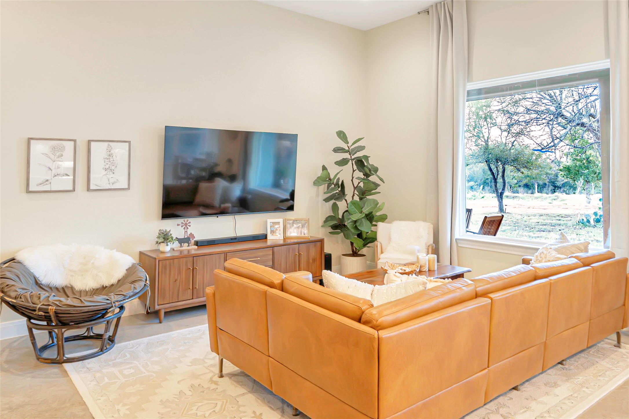 0 Oil Field Road Lockhart, TX 78644 - Photo 28 of 36 a living room with furniture a flat screen tv and a floor to ceiling window