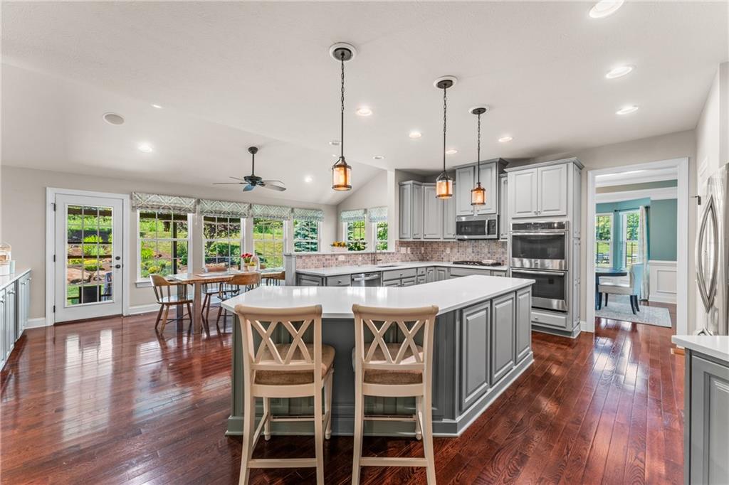 211 Taylor Ridge Lane Mars, PA 16046 - Photo 14 of 50 a kitchen with a table chairs stove and wooden floor