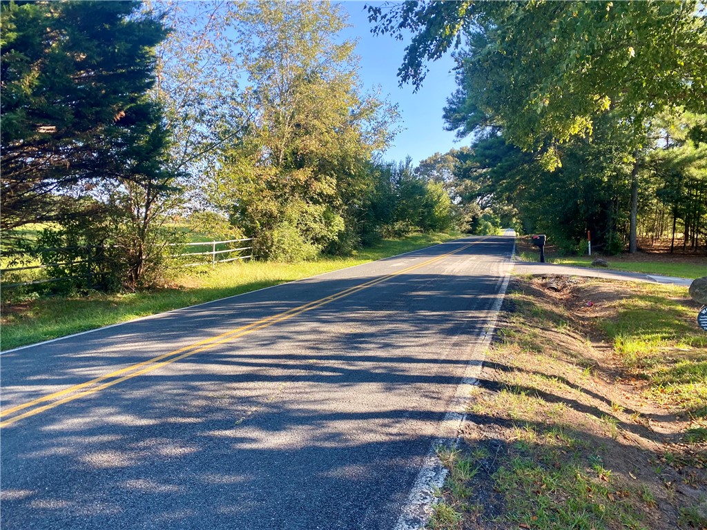 327 Five Forks Road Anderson, SC 29621 - Photo 13 of 31 Mature trees line the paved road leading toward the property entrance.