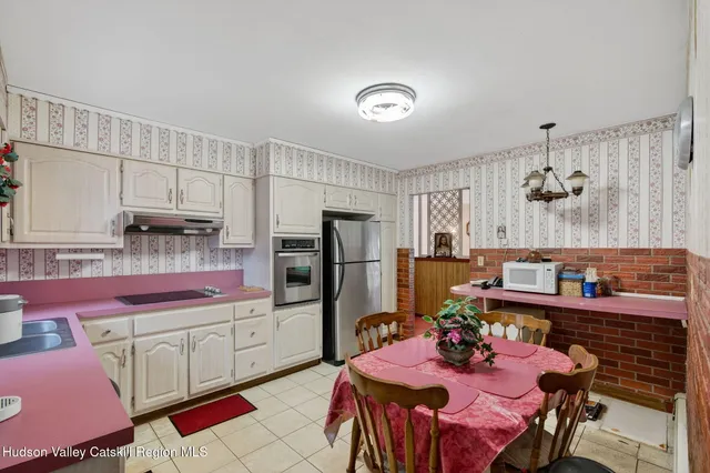 a kitchen with a sink refrigerator and cabinets