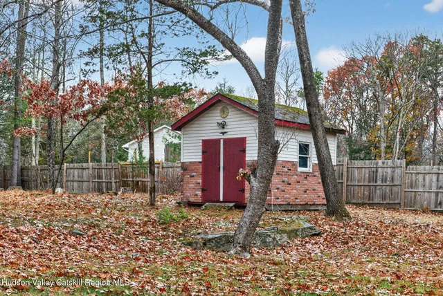a wooden bench sitting in middle of a yard