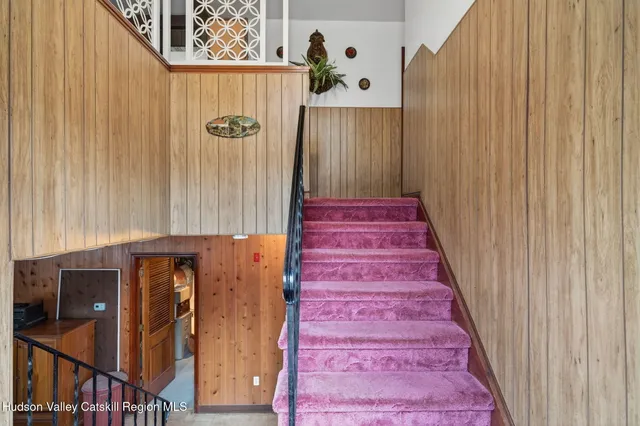 a view of an entryway with wooden floor