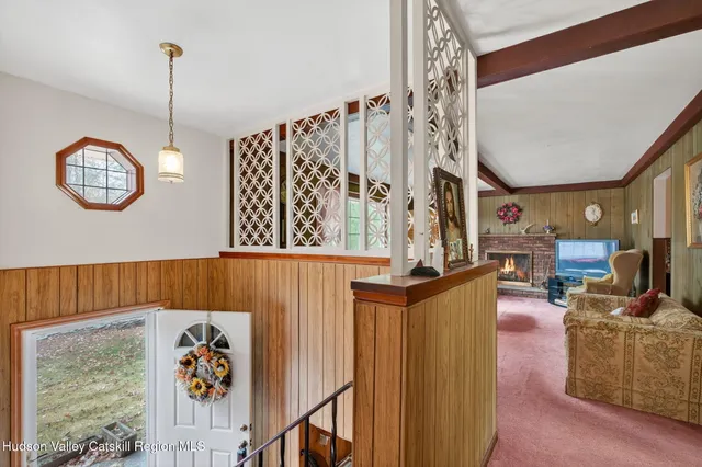a view of a hallway with couch and dining table