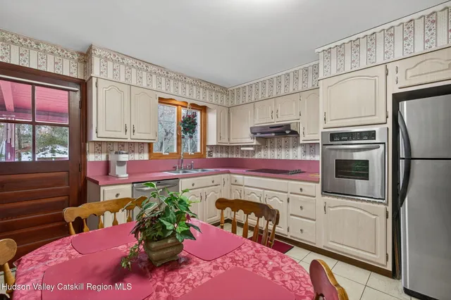 a kitchen with a refrigerator sink and cabinets