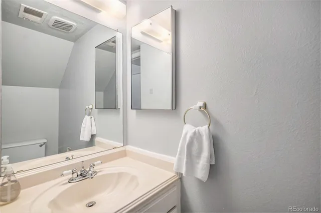 a bathroom with a sink and vanity