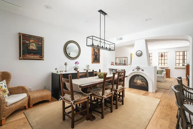 a kitchen with stainless steel appliances kitchen island granite countertop a sink a stove and white cabinets