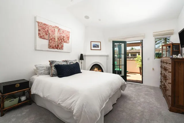 an empty room with window and mirror