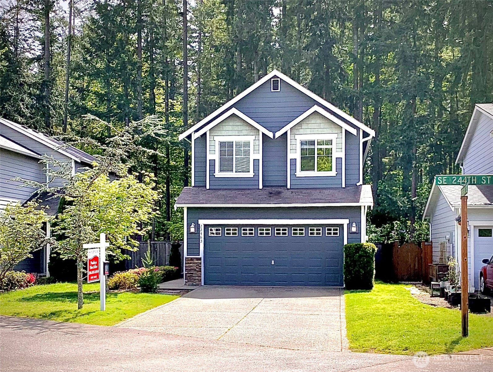 22463 Southeast 244th Street Maple Valley, WA 98038 - Photo 1 of 26 a front view of a house with a yard and garage