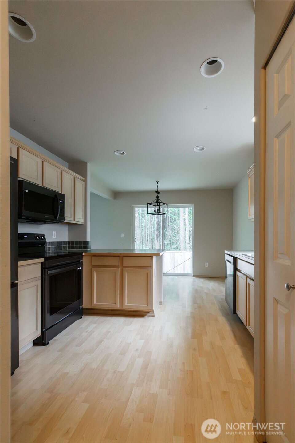 22463 Southeast 244th Street Maple Valley, WA 98038 - Photo 12 of 26 a large kitchen with a stove and a refrigerator