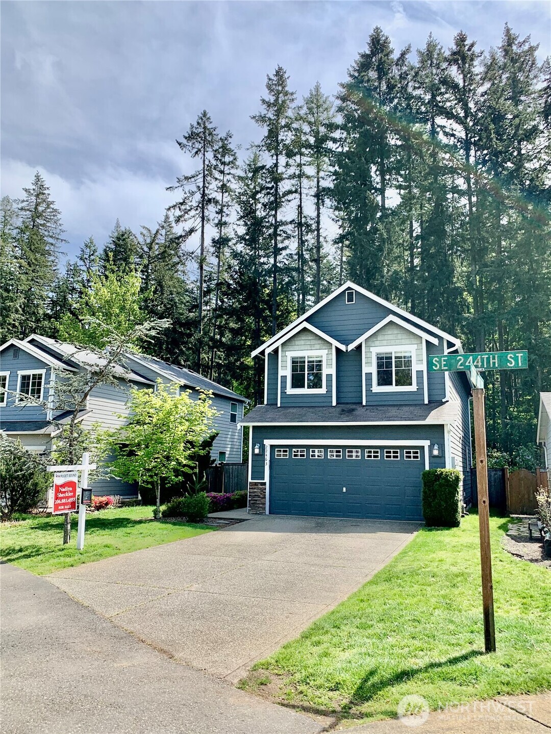 22463 Southeast 244th Street Maple Valley, WA 98038 - Photo 22 of 26 a front view of a house with a yard and lake view