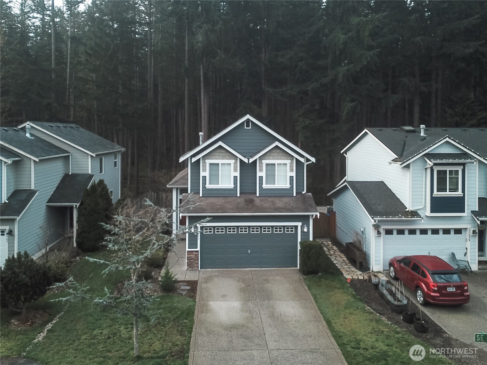 22463 Southeast 244th Street Maple Valley, WA 98038 - Photo 3 of 26 a front view of a house with a yard and garage