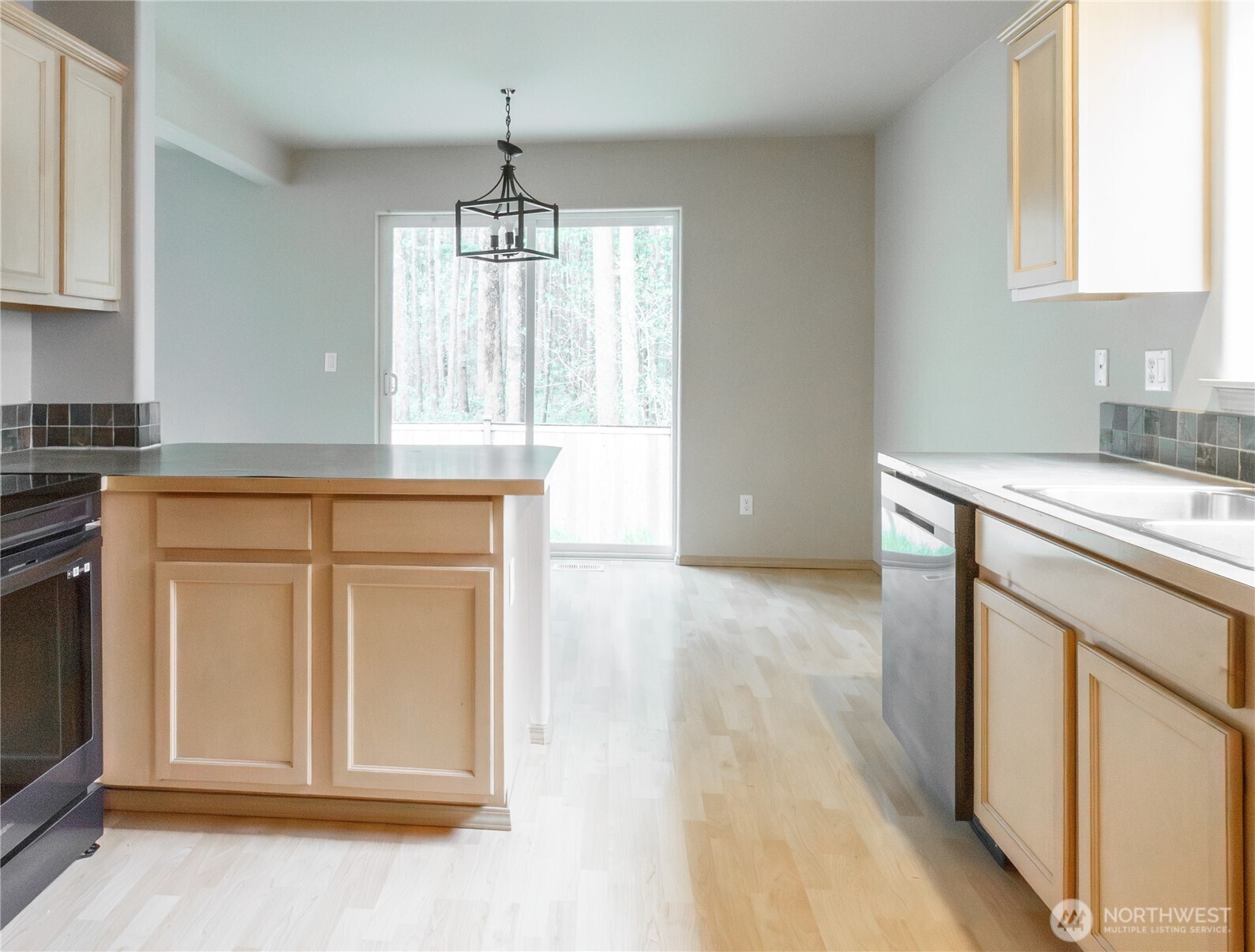 22463 Southeast 244th Street Maple Valley, WA 98038 - Photo 8 of 26 a kitchen with granite countertop a sink stainless steel appliances and cabinets