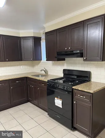 a kitchen with a sink and a stove