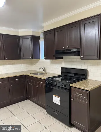 a kitchen with sink cabinets and appliances