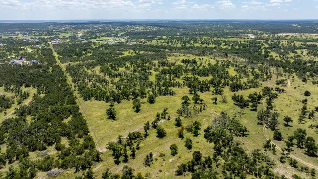 a view of yard with swimming pool and green space