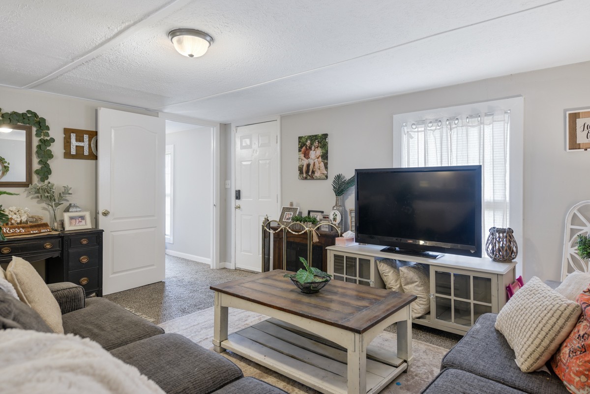 6016 Highland Road Orlinda, TN 37141 - Photo 15 of 34 a living room with furniture and a flat screen tv