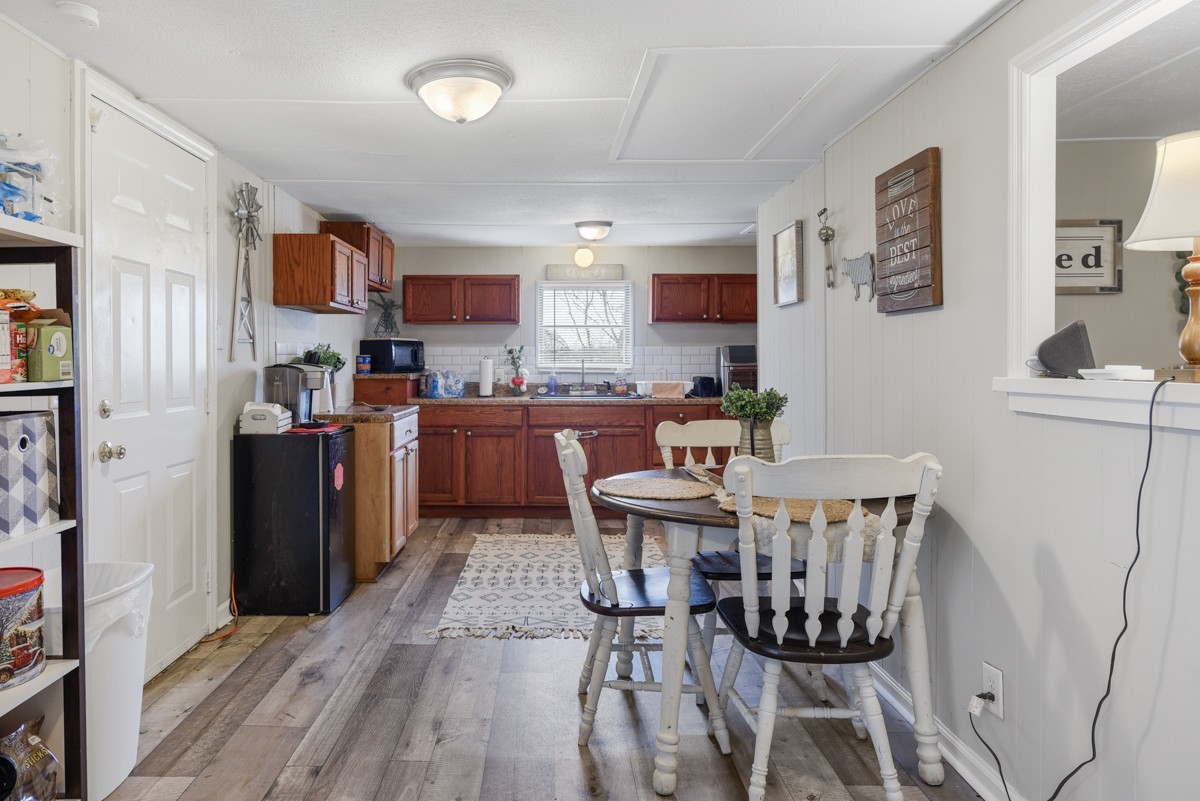 6016 Highland Road Orlinda, TN 37141 - Photo 16 of 34 a view of a dining room with furniture and wooden floor