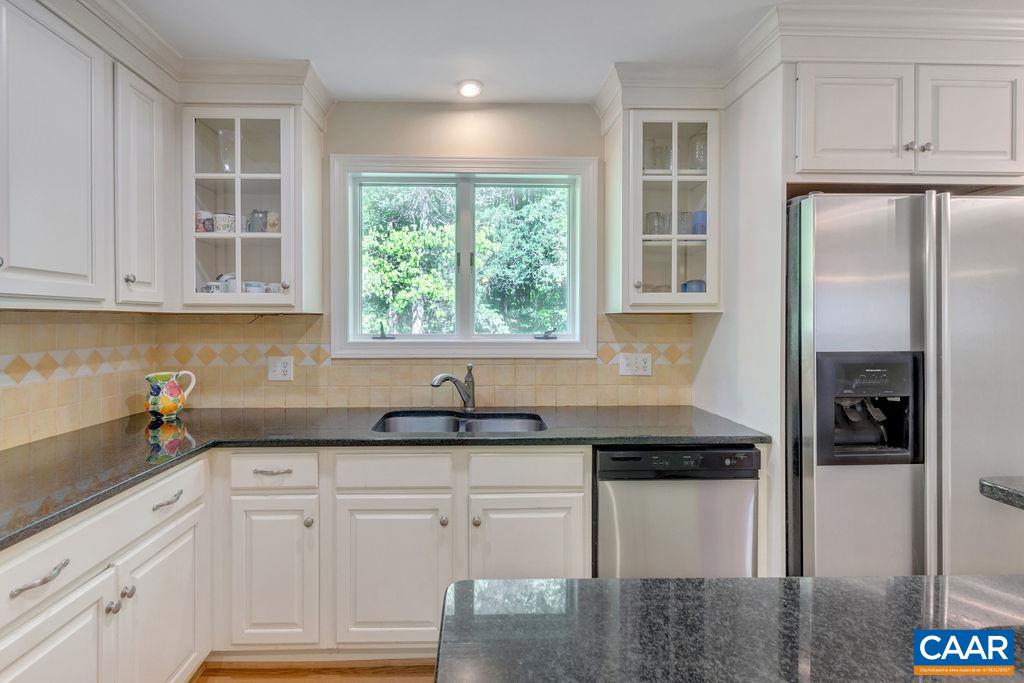 1970 Stillhouse Road Charlottesville, VA 22901 - Photo 17 of 51 a kitchen with granite countertop white cabinets and a window