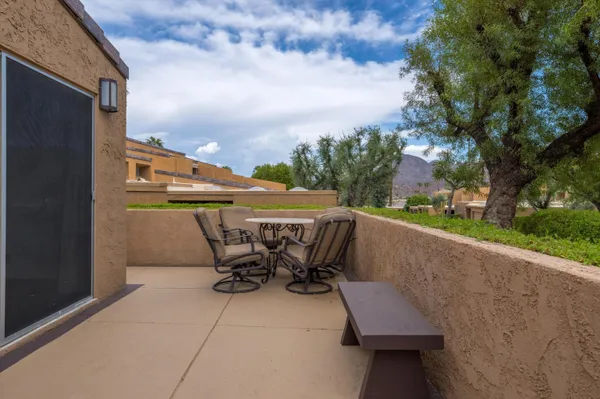a view of a patio with table and chairs floor to ceiling window with wooden floor