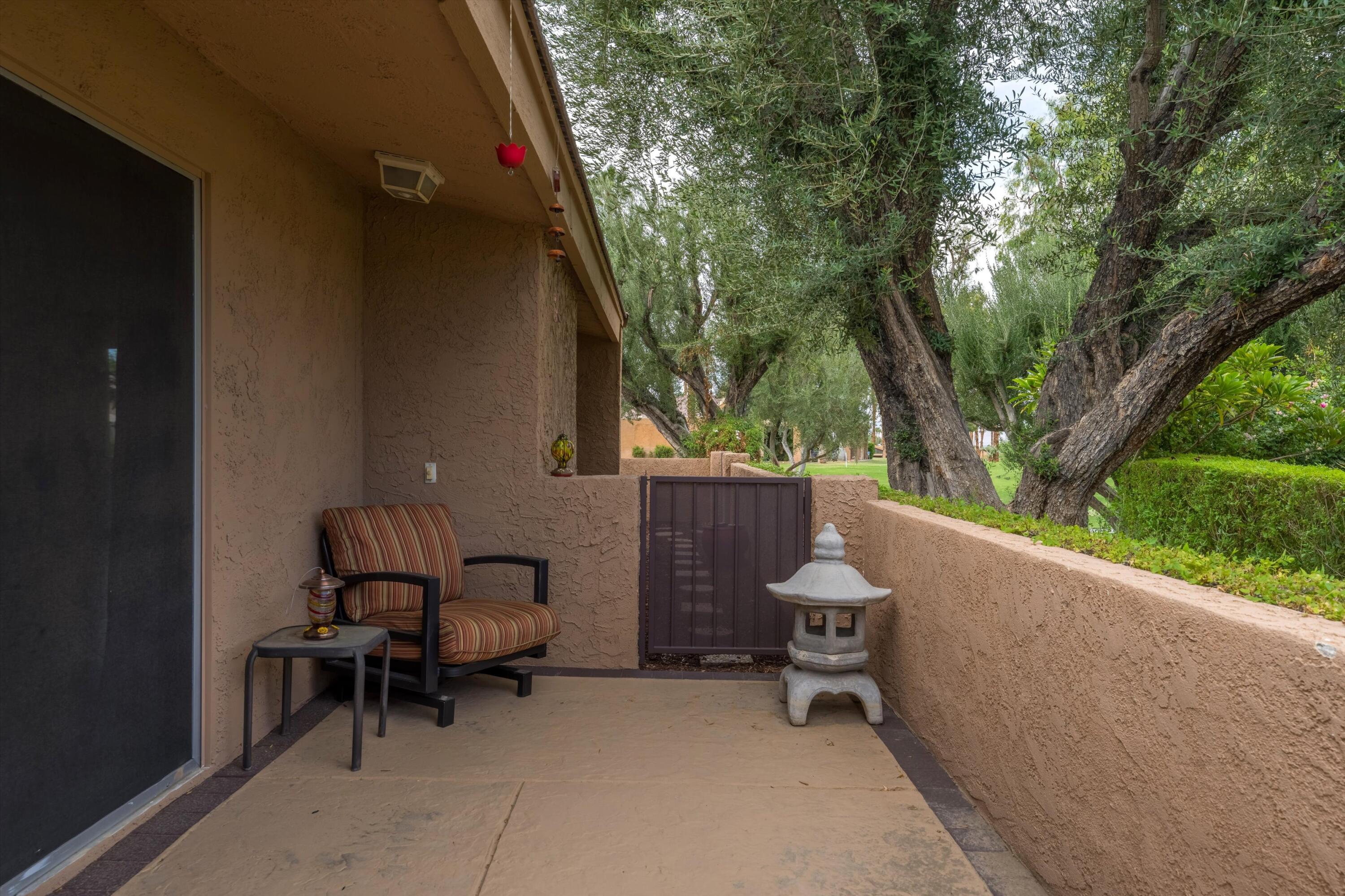 73476 Dalea Lane Palm Desert, CA 92260 - Photo 15 of 37 a backyard of a house with a table and chairs