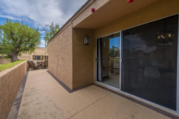 a view of an outdoor sitting area with furniture and backyard