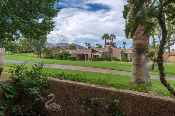 a view of a house with a yard and tree s