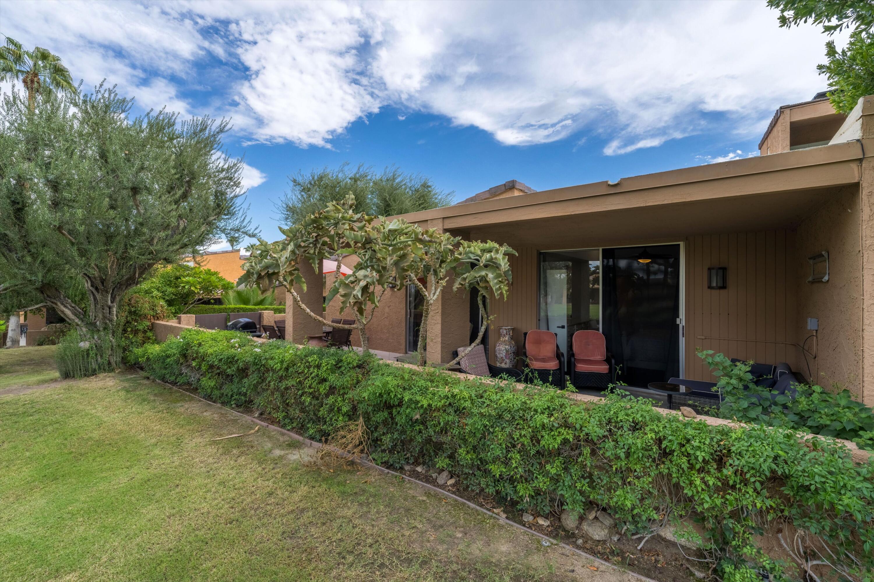 73476 Dalea Lane Palm Desert, CA 92260 - Photo 23 of 37 front view of a house with a yard