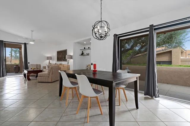a living room with furniture and a ceiling fan