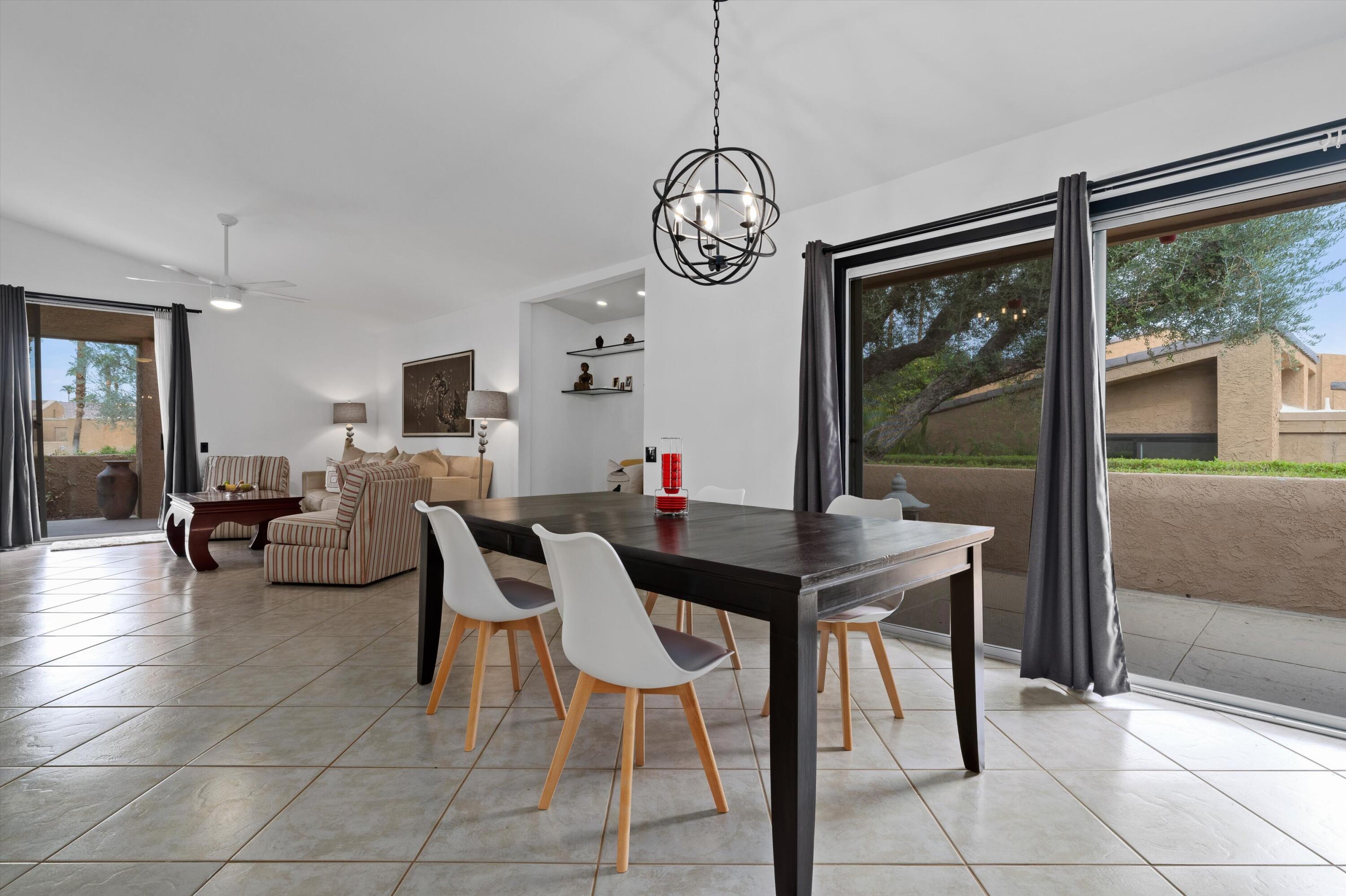 73476 Dalea Lane Palm Desert, CA 92260 - Photo 25 of 37 a view of a dining room with furniture wooden floor and a chandelier