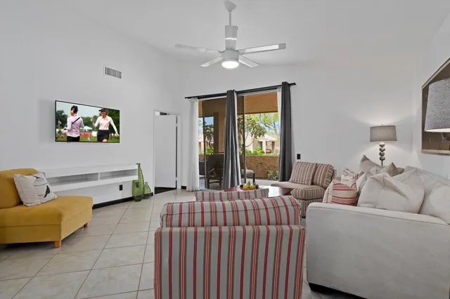 a bedroom with a bed and a ceiling fan