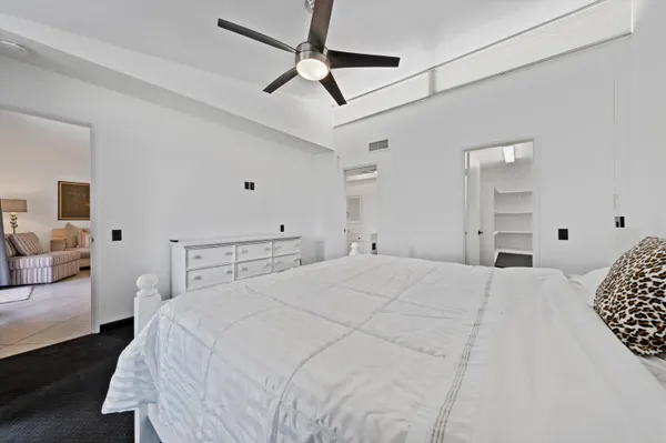 a bedroom with a large bed and a window