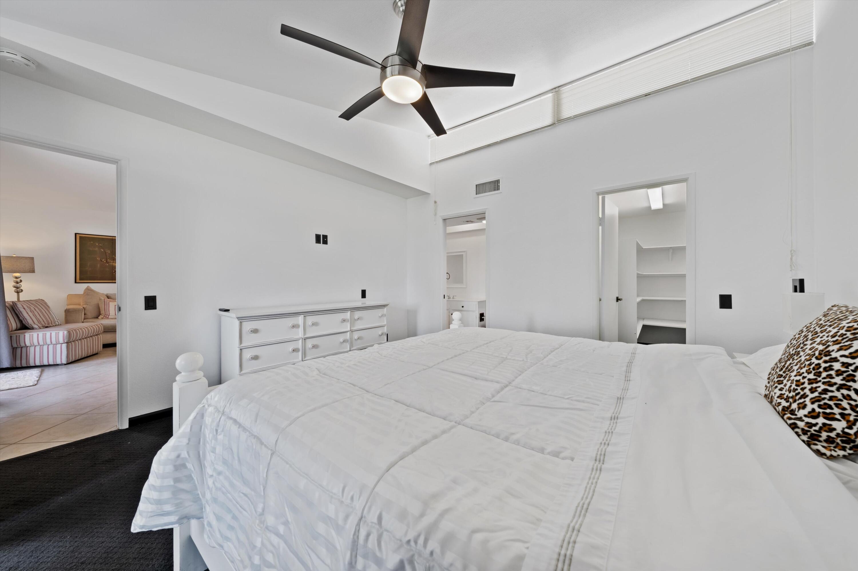 73476 Dalea Lane Palm Desert, CA 92260 - Photo 30 of 37 a bedroom with a bed and a chandelier