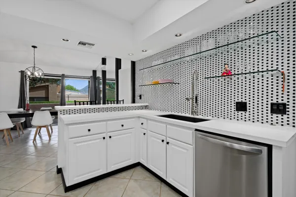 a kitchen with granite countertop white cabinets and white appliances