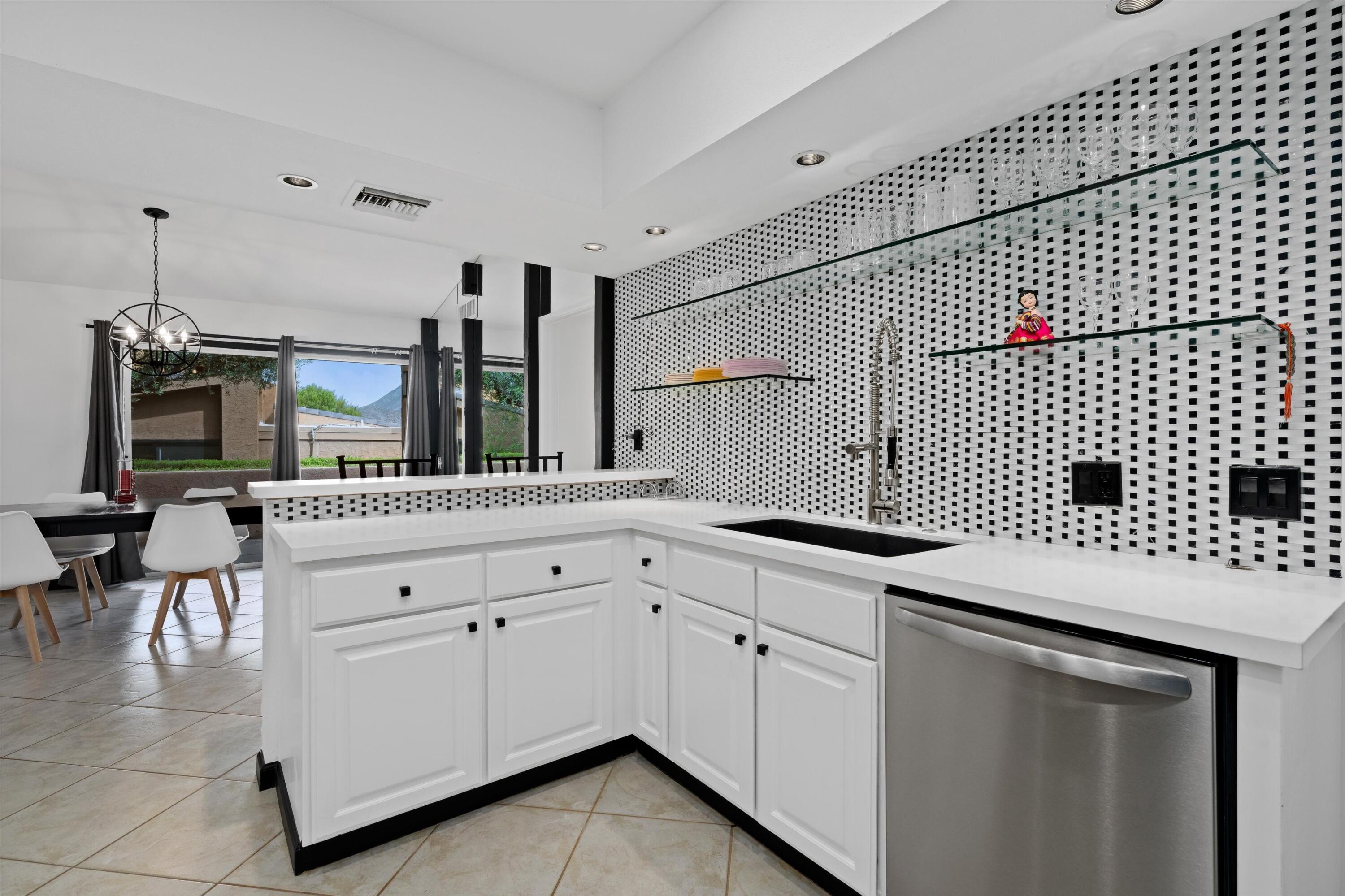 73476 Dalea Lane Palm Desert, CA 92260 - Photo 3 of 37 a kitchen with granite countertop white cabinets and white appliances