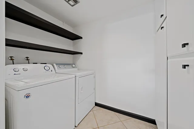 a bed sitting in a room next to a window