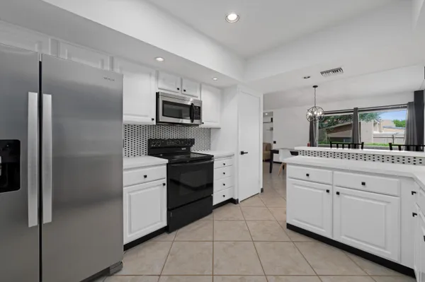 a kitchen with stainless steel appliances a refrigerator stove and sink