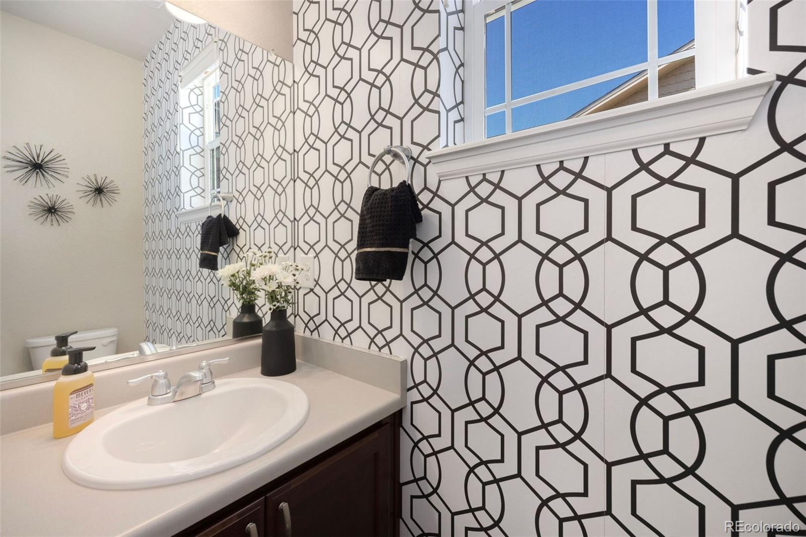 8809 Foxfire Street Firestone, CO 80504 - Photo 13 of 32 a bathroom with a sink and a mirror