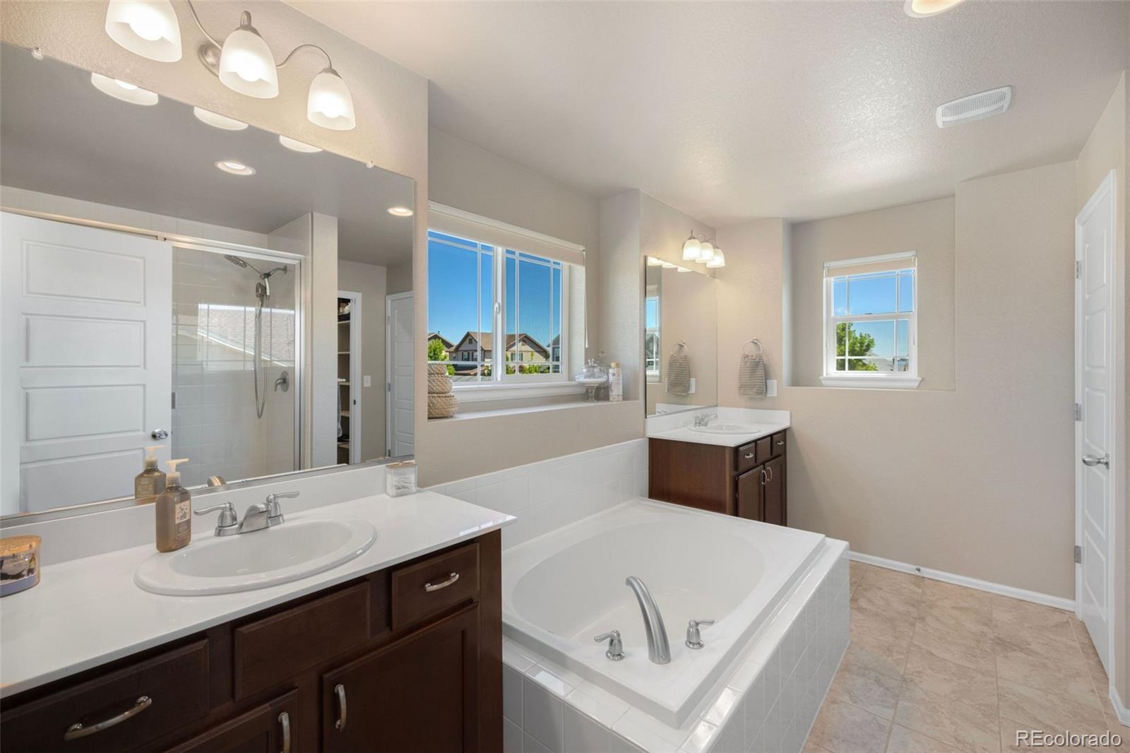 8809 Foxfire Street Firestone, CO 80504 - Photo 20 of 32 a bathroom with a sink a vanity and a mirror