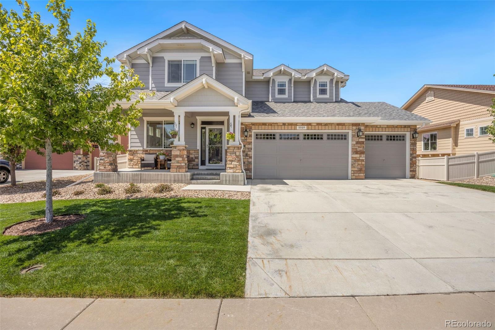 8809 Foxfire Street Firestone, CO 80504 - Photo 2 of 32 a front view of a house with a yard