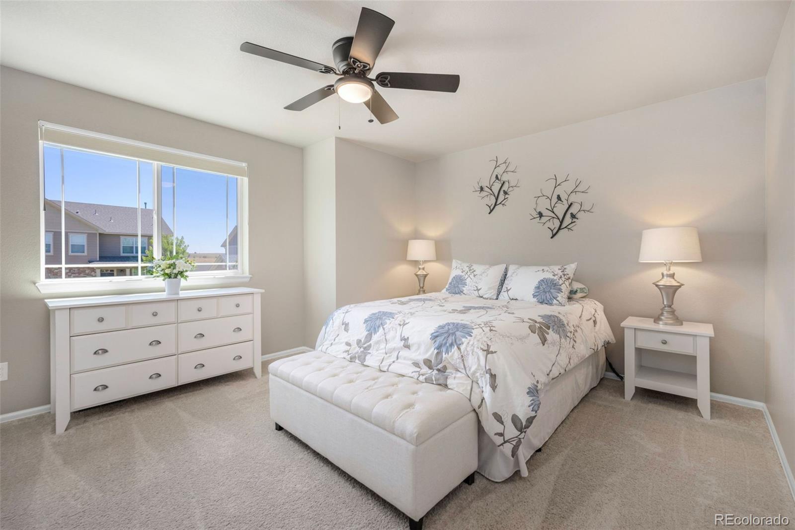 8809 Foxfire Street Firestone, CO 80504 - Photo 23 of 32 a spacious bedroom with a bed and a dresser