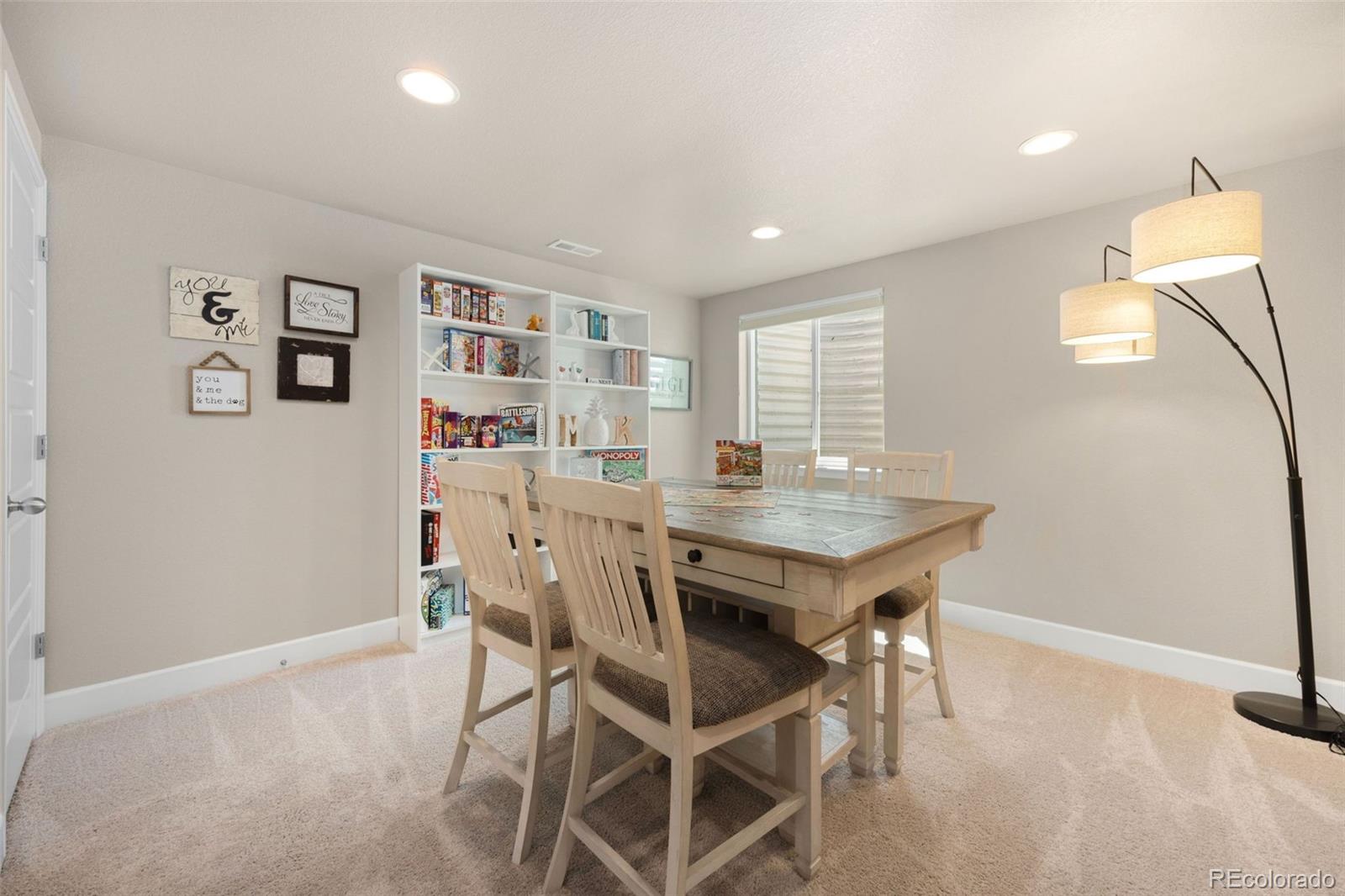 8809 Foxfire Street Firestone, CO 80504 - Photo 24 of 32 a room with a dining table and chairs
