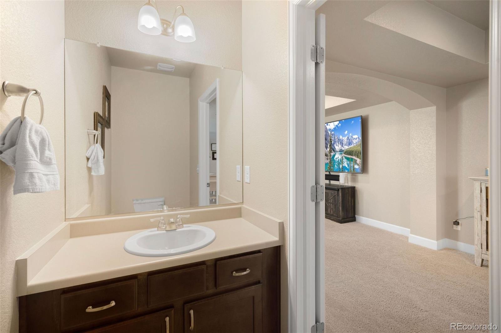 8809 Foxfire Street Firestone, CO 80504 - Photo 26 of 32 a bathroom with a sink and a mirror