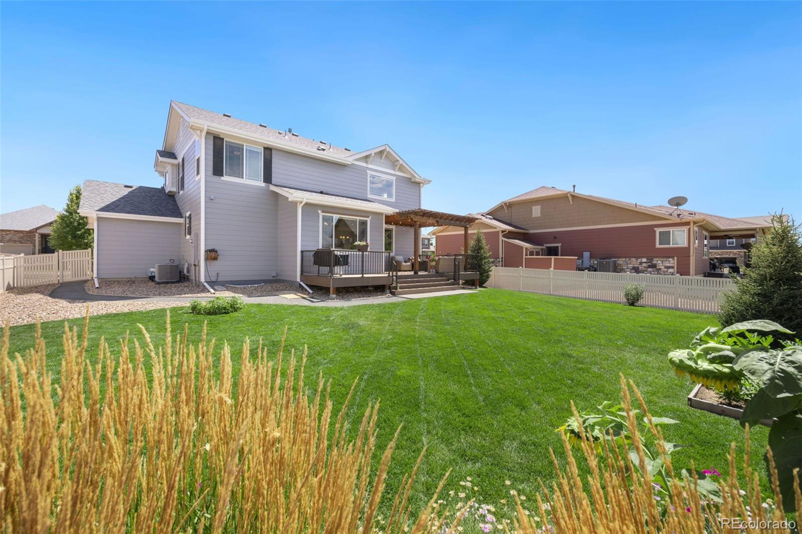 8809 Foxfire Street Firestone, CO 80504 - Photo 30 of 32 a view of a house with a big yard and potted plants