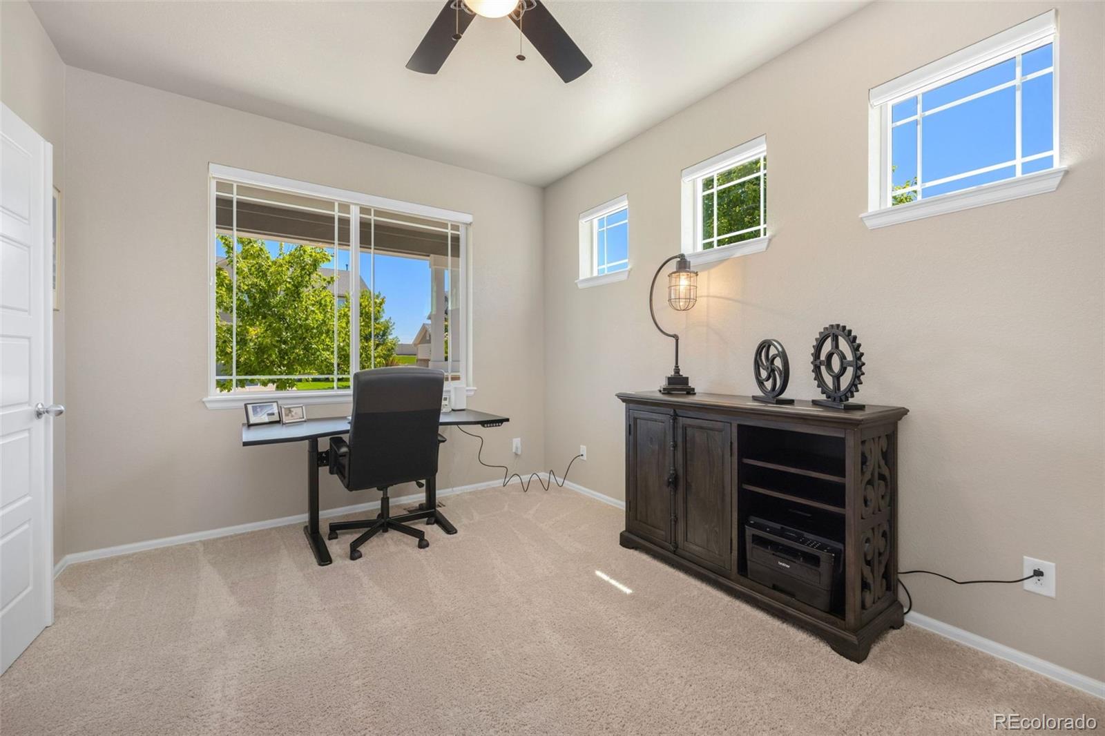 8809 Foxfire Street Firestone, CO 80504 - Photo 5 of 32 a view of a workspace with furniture and a window
